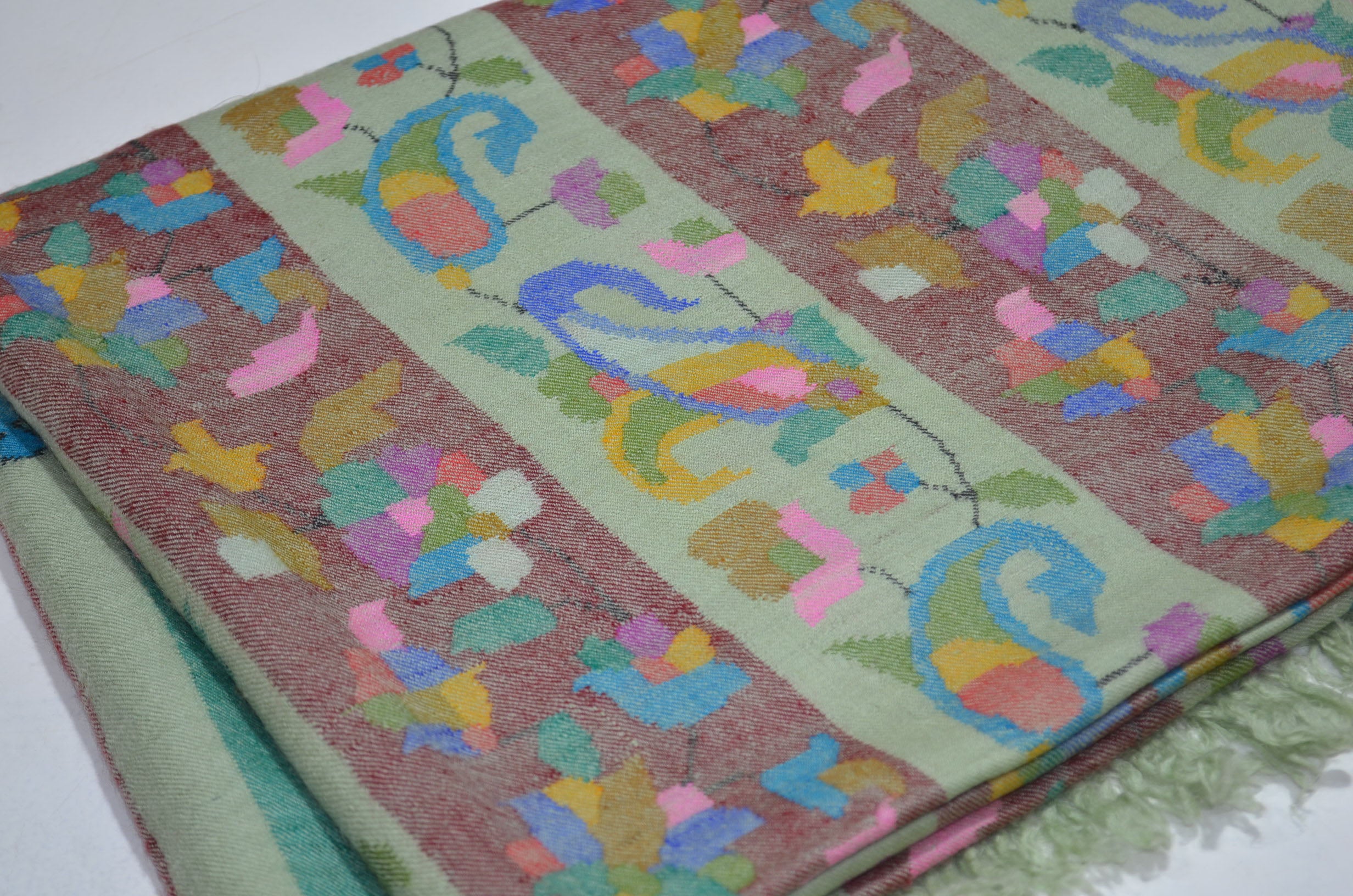 A luxurious Cashmere Pashmina jamawar kani shawl made from highest quality fibers. This kani shawl is a signature of royality. Buy and feel the softness and warmth of this pashmina kani shawl. Hand embroidered in Kashmir | purekashmir.com