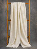 Ivory cashmere scarf for women draped on wooden branch — handwoven pure Kashmir pashmina