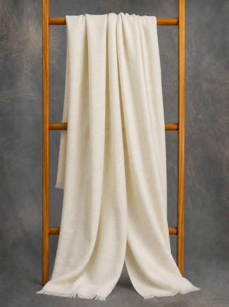 Ivory cashmere scarf for women draped on wooden branch — handwoven pure Kashmir pashmina