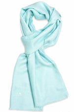 arctic blue scarf draped in a looped style on a plain white background