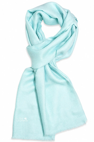arctic blue scarf draped in a looped style on a plain white background
