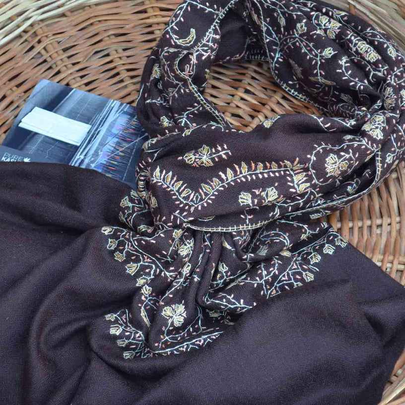 Brown merino wool cashmere embroidered scarf on a basket